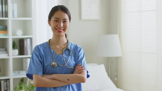 Portrait of young Asian woman nurse smiling in nursing home or hospital. Look at camera