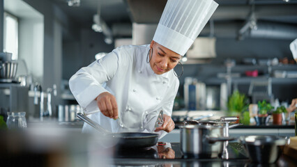 Restaurant Kitchen: Black Female Chef Fries Organic Patty on a Pan, Seasons it and Flips Cutlet...