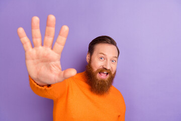 Portrait of overjoyed good mood handsome male meet his friends say hello isolated on purple color...