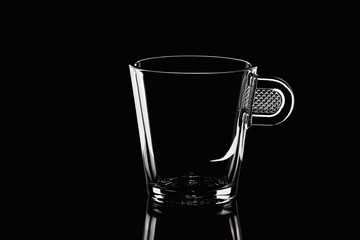 Photo of a glass coffee cup on a black background