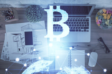 Blockchain theme hologram drawings over computer on the desktop background. Top view. Double exposure.