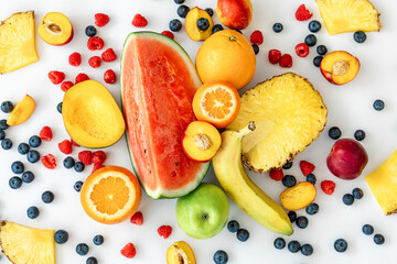 Tropical fruits on a white background top view.