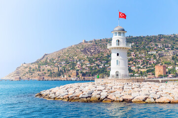 Fototapeta na wymiar Alanya lighthouse with fortress on the background on a sunny summer day