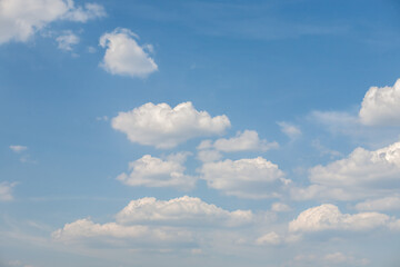 Rare cumulus clouds against a clear blue sky. High quality photo