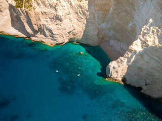 aerial view of a sailboat near a cliff in sea's greece