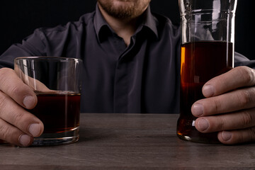 Glass cup with alcoholic drinks in hand.