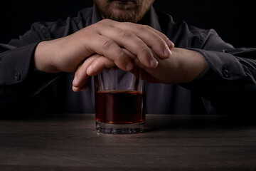 The man refuses to drink alcohol. Against alcohol.