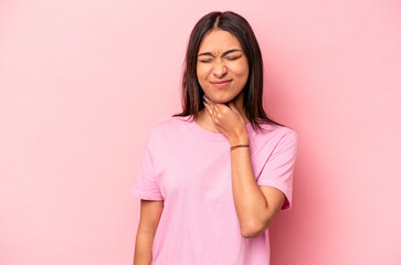 Fototapeta premium Young hispanic woman isolated on pink background suffers pain in throat due a virus or infection.