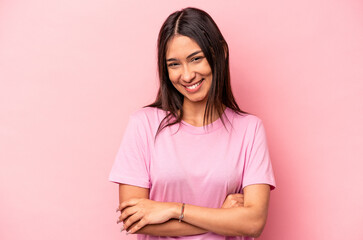 Fototapeta premium Young hispanic woman isolated on pink background laughing and having fun.