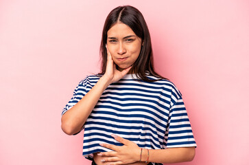 Obraz premium Young hispanic woman isolated on pink background blows cheeks, has tired expression. Facial expression concept.