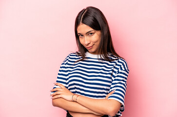 Obraz premium Young hispanic woman isolated on pink background unhappy looking in camera with sarcastic expression.
