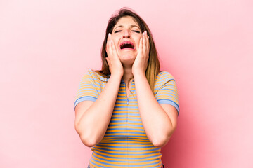 Young caucasian woman isolated on pink background whining and crying disconsolately.