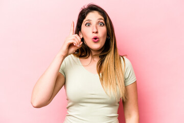 Fototapeta premium Young caucasian woman isolated on pink background having some great idea, concept of creativity.