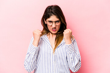 Young caucasian woman isolated on pink background upset screaming with tense hands.