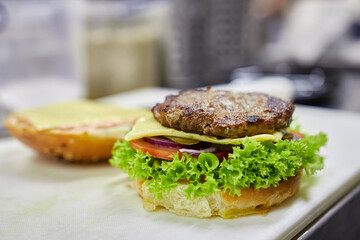 Make a burger with beef. Fast food.