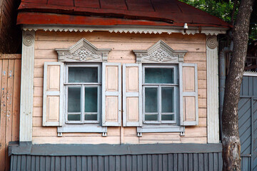 Windows in a painted old rustic wooden house