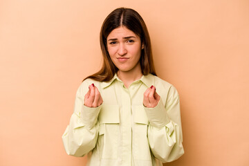 Young hispanic woman isolated on beige background showing that she has no money.