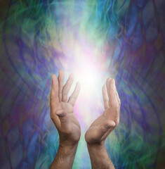 Channelling powerful healing energy to you - male cupped hands sending out healing intention against a web like matrix blue green energy field background and space for copy 
