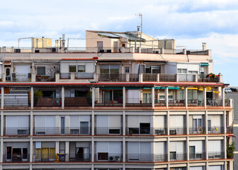 Fototapeta na wymiar Facade of a building. Residential building with balconies. Colorful buildings and hotel apartments. Facade of residential building in Spain. House with window and balcony. Buildings architecture..