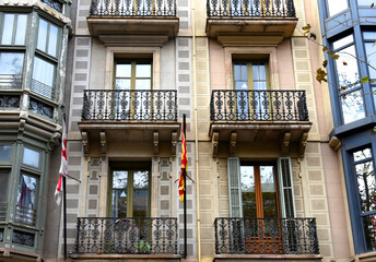Facade of a building. Residential building with balconies. Colorful buildings and hotel apartments. Facade of residential building in Spain. House with window and balcony. Buildings architecture..