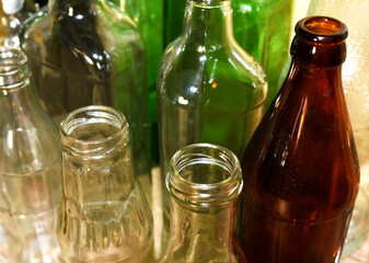 Glass waste for recycle. Empty glass bottles from beer wine and champagne. Ecology and environment...
