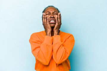 Young african american woman isolated on blue background whining and crying disconsolately.