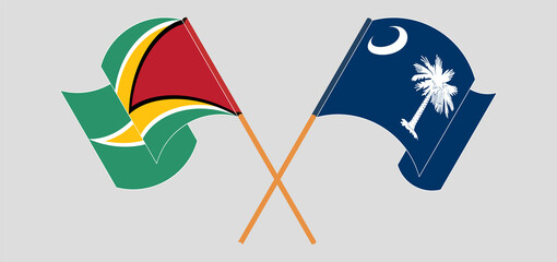 Crossed and waving flags of Guyana and The State of South Carolina