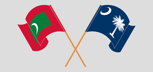 Crossed and waving flags of Maldives and The State of South Carolina