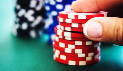 Stack of red casino chips in gambler hand