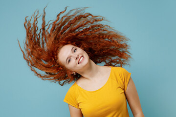 Young cheerful happy redhead woman 20s wearing yellow t-shirt dance waving fooling around have fun...