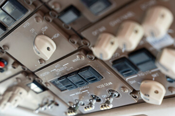 Close up on a light switch panel int he cockpit of a 757 commercial passenger airplane.