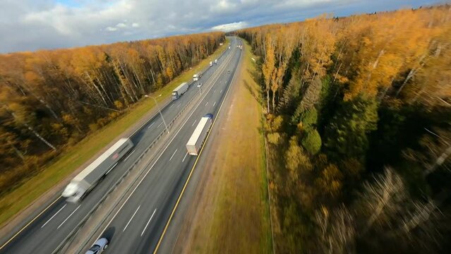 Aerial dynamic scene of fast drone speed chasing a truck, highway, Europe