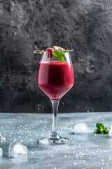 Blackberry and raspberry smoothies in glass with mint leaf and raw beeries on dark background. vertical image. top view. place for text