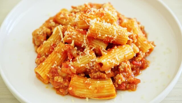 Bolognese rigatoni pasta with cheese - traditional Italian pasta