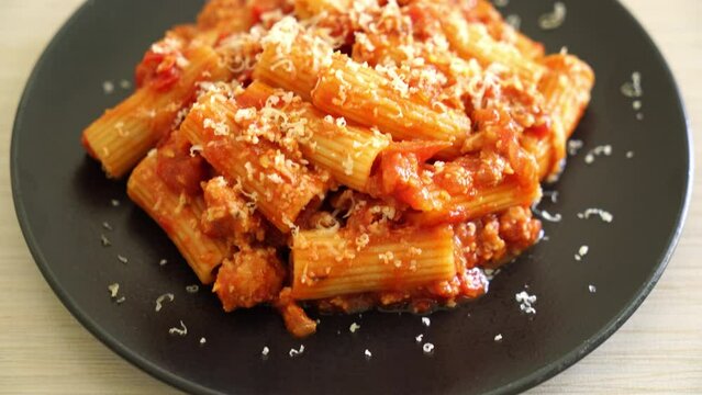 Bolognese rigatoni pasta with cheese - traditional Italian pasta