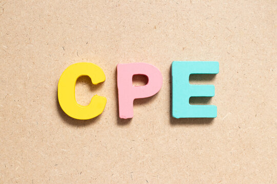 Color Alphabet Letter In Word CPE (Abbreviation Of Continuing Professional Education, Customer Premises Equipment Or Cost Per Engagement) On Wood Background