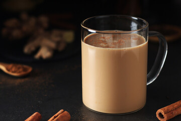A cup with masala chai in low key