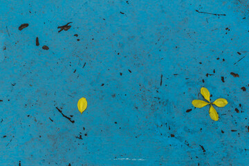 Dirty blue background with yellow leaves