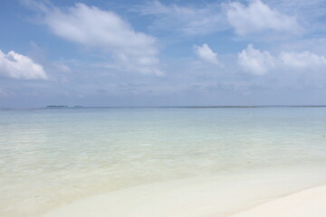 The perfect beach. The invisible horizon line. Weightless clouds.