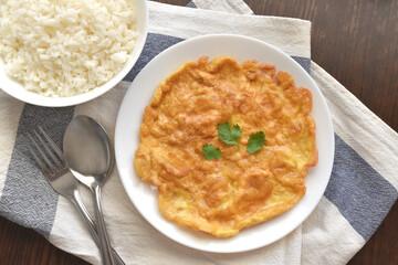 Thai omelette on a white plate. Flat lay top view photo. Food from above.