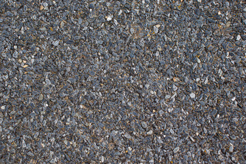 Texture of the sheet of roofing material. Small pebbles glued to the surface of the roofing material.