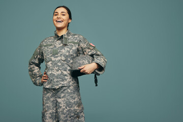 Cheerful female soldier smiling in a studio