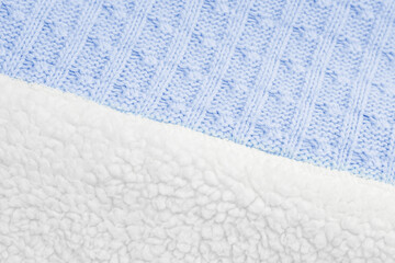 winter blanket for babies texture with imitation sheep wool. Close-up textured blue knitted fabric with white lambswool on the back, top view.