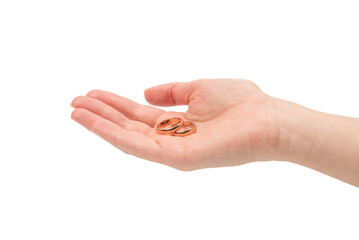Two golden rings in a woman hand isolated on a white background.