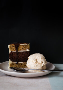 Slice of chocolate caramel cake with ice cream