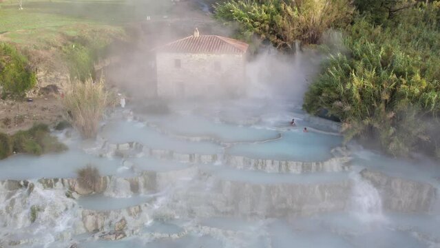Serene tourist attraction natural sulfur hot spring in Italian countryside, aerial