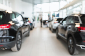 Vehicle purchase, rental, lease. Blurred view of automobile dealership store interior with new modern cars, copy space