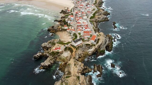 Aerial view of island Baleal naer Peniche on the shore of the ocean in west coast of Portugal. Baleal Portugal with incredible beach and surfers