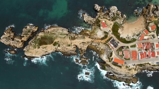 Aerial view of island Baleal naer Peniche on the shore of the ocean in west coast of Portugal. Baleal Portugal with incredible beach and surfers