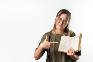 Young happy woman student pointing to a book on white background